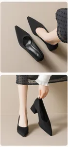 Vista macro de zapatos de salón negros con punta fina y tacón grueso de ante