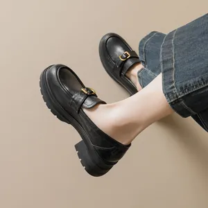 Women's black platform loafers with gold metal buckle and chunky slip-resistant sole