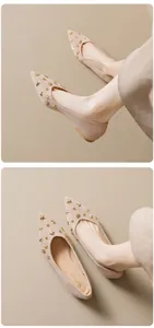 Macro detail of beige pointed-toe flat shoes with gold star and dot rivet embellishments
