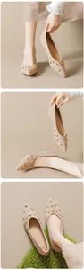 Detailed close-up of apricot suede pointed-toe flats with gold star metallic studs