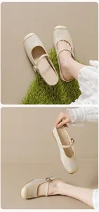Detail of beige woven Mary Jane mules featuring raffia texture and adjustable buckle strap