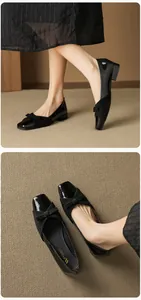 Detail of square toe pumps with bow accent, mix of patent leather and suede textures