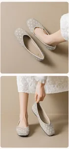 Detail of pointed-toe ballet flats with pearl and rhinestone diamond grid embroidery