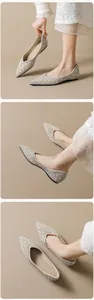 Detail of pointed-toe flats with champagne mesh and crystal pearl embellishments