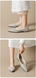Macro detail of pointed-toe flats with champagne pearls and sparkling rhinestone patterns