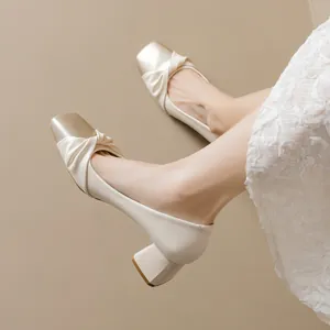 Elegant off-white block heel pumps with champagne gold square toe and knot detail