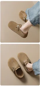 Detail of brown suede clogs with metal buckle and decorative stitching on the toe