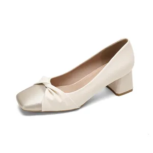 Elegant beige satin block heel pumps with square gold toe and bow tie detail