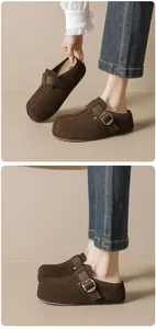 Close-up of brown suede leather mule with adjustable buckle strap and non-slip sole