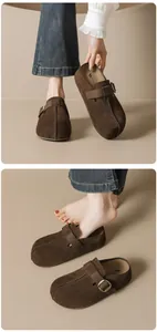 Detailed view of dark brown suede mule slippers featuring retro metal buckle and leather texture