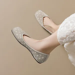 Elegant pointed flat shoes for women featuring sparkling rhinestones and pearl embellishments