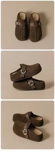 Detail view of brown suede clogs with adjustable leather straps and metal buckles