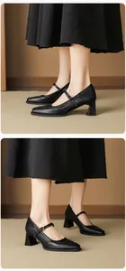 Detail view of black leather Mary Jane shoes with square toe and steady block heel