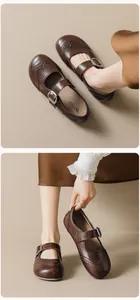 Close-up of vintage brown leather Mary Jane shoes with classic brogue carved details