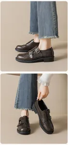 Close-up of women's dark brown monk strap loafers featuring intricate brogue detailing