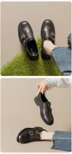 Detail of dark brown double monk strap brogue shoes with carved punch hole patterns
