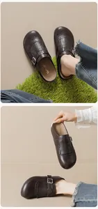 Close-up of retro dark brown leather mule with tassel detail and adjustable metal buckle