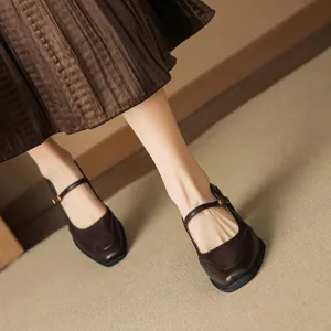 Retro brown leather Mary Jane heels with square toe and ankle strap on a model