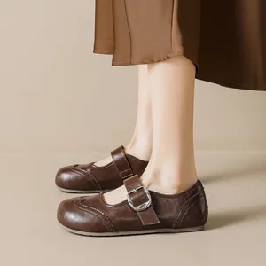 Vintage brown Brogue Mary Jane shoes with adjustable strap and decorative floral carvings