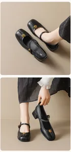 Detail of black leather Mary Jane shoes with golden rose buckle and chunky heel