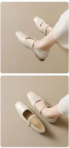 Close-up of retro square toe cream leather Mary Jane flats with slim buckle strap