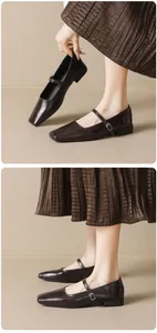 Detail showing square toe dark brown leather Mary Jane flat shoes with adjustable strap