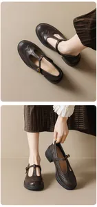Macro detail of dark brown T-strap Mary Jane shoes with Brogue carving and platform heel