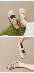 Close-up of beige Mary Jane flats featuring brogue perforations and double straps