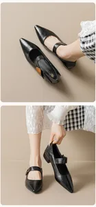 Close-up of black pointed-toe Mary Jane shoes with vintage buckle and elegant block heel