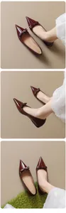 Close-up of wine red patent leather pointed-toe flats with elegant bow detail