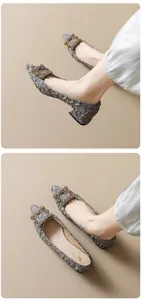 Detail of grey pleated pointed-toe mid-heel shoes with a luxury crystal buckle