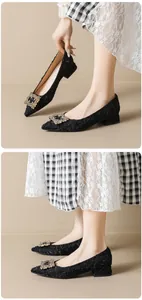 Detail of black pointed-toe pump with embossed texture and sparkling crystal buckle