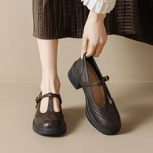 Vintage brown leather T-strap Mary Jane shoes with platform heels and brogue detailing