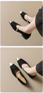 Detail of French style Mary Jane flats featuring a black body and metallic contrast toe cap