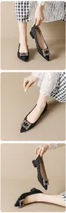Detailed view of pointed toe heels with sparkly rhinestone buckle and textured fabric