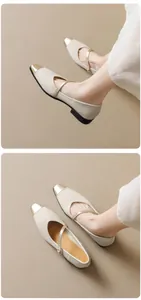 Detail of cream Mary Jane flats featuring a gold toe cap and delicate ankle strap