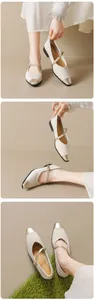 Close-up of beige pointed Mary Jane flats with gold toe cap and crisscross ankle straps