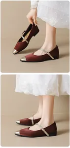 Detail view of Mary Jane flats with burgundy silk fabric and metallic silver toe cap