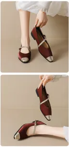 Detail of burgundy satin Mary Jane flat with gold metal toe cap and buckle strap