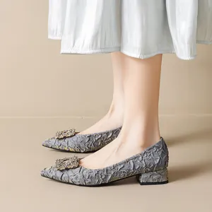 Gray pointed-toe chunky heel pumps with rhinestone buckle and relief texture