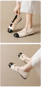 Détail de la ballerine Mary Jane matelassée avec boucle camélia dorée et bout noir