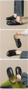 Detail of vintage brogue carving on black mule clogs with adjustable metal buckle strap
