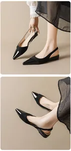 Detail of black slingback flats with pointed patent toe and matte suede texture contrast