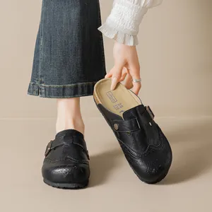 Retro black carved brogue mules with cork footbed and decorative metal buckle strap