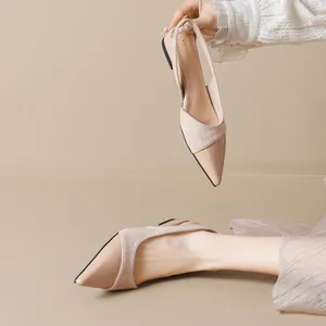 Elegant nude pointed-toe slingback flats in glossy patent and suede leather patchwork