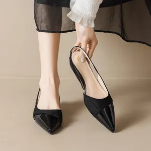 Elegant black pointed-toe slingback heels featuring a mix of patent and suede materials