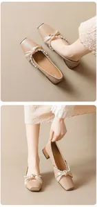 Detail view of square toe Mary Jane shoes with satin bow and white pearl accents