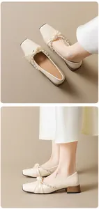 Detail of square-toe pumps with pearl bow straps and textured low block heels
