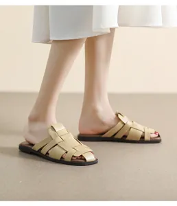 Detail of beige woven cross-strap sandals with minimalist square toe and flat brown sole