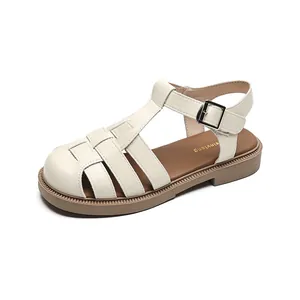 Beige woven closed-toe Roman sandals with chunky sole and metallic buckle closure
